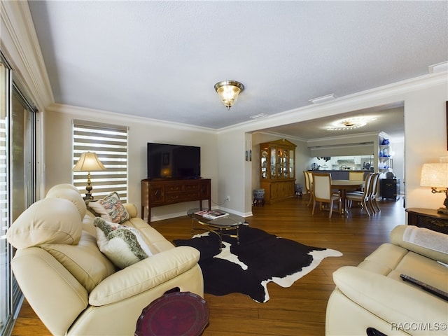 living room with crown molding and dark hardwood / wood-style flooring