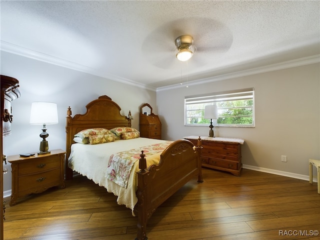 bedroom with a textured ceiling, dark hardwood / wood-style floors, ceiling fan, and crown molding