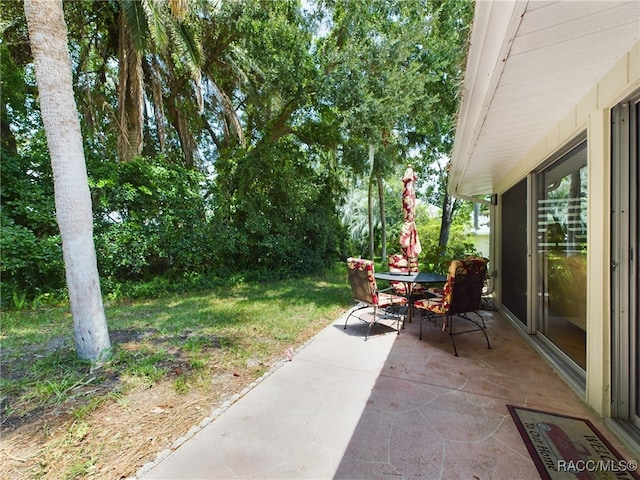 11487 W Bayshore Dr, Crystal River, FL 34429 - view of grassy yard with a patio and outdoor dining space