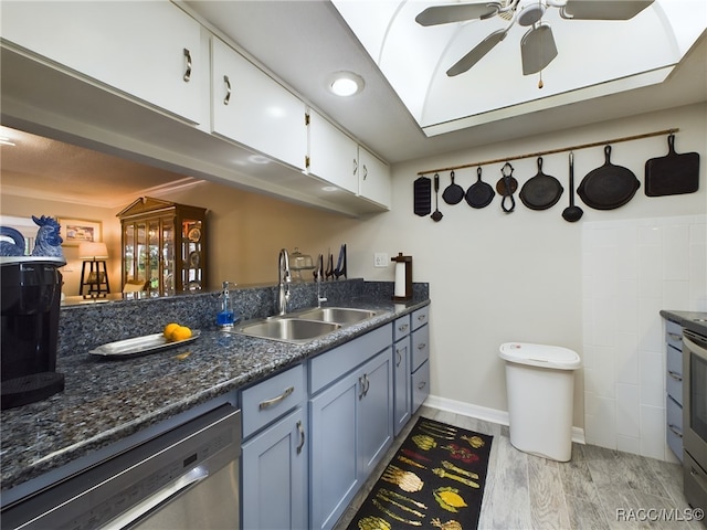 kitchen with stainless steel appliances, ceiling fan, sink, light hardwood / wood-style flooring, and white cabinets