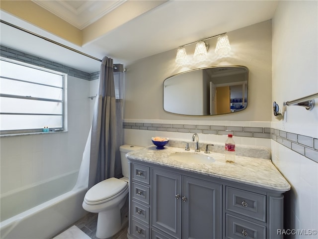 full bathroom with toilet, shower / bath combo with shower curtain, crown molding, and tile walls