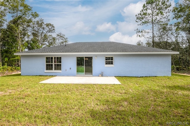 back of property featuring a yard and a patio area