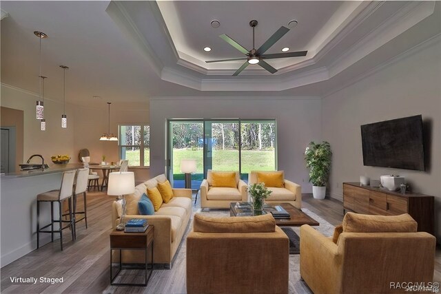 4496 N Elkcam Blvd, Beverly Hills, FL 34465 - living room with crown molding, a raised ceiling, a ceiling fan, wood finished floors, and recessed lighting