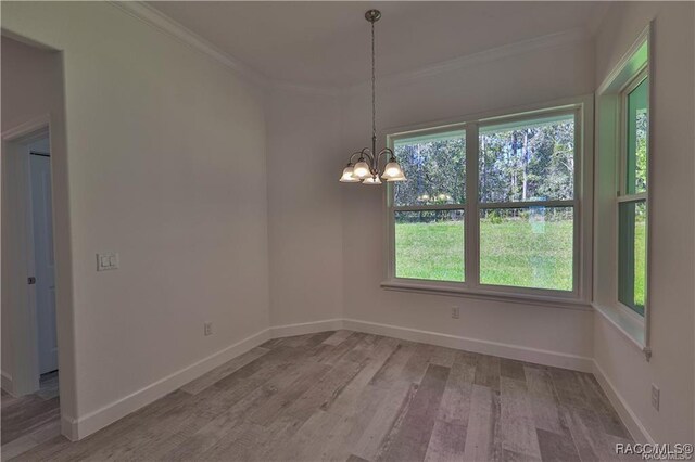 4496 N Elkcam Blvd, Beverly Hills, FL 34465 - unfurnished dining area featuring a chandelier, ornamental molding, and light wood-type flooring