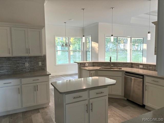 4496 N Elkcam Blvd, Beverly Hills, FL 34465 - kitchen featuring stainless steel dishwasher, healthy amount of natural light, decorative backsplash, a center island, and ornamental molding