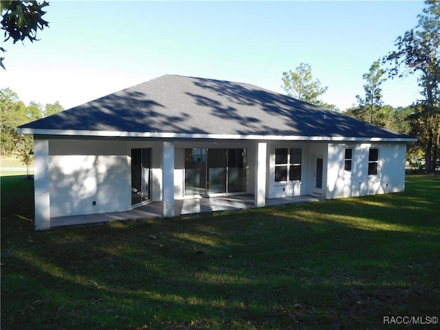 4496 N Elkcam Blvd, Beverly Hills, FL 34465 - back of house with a patio area and a yard