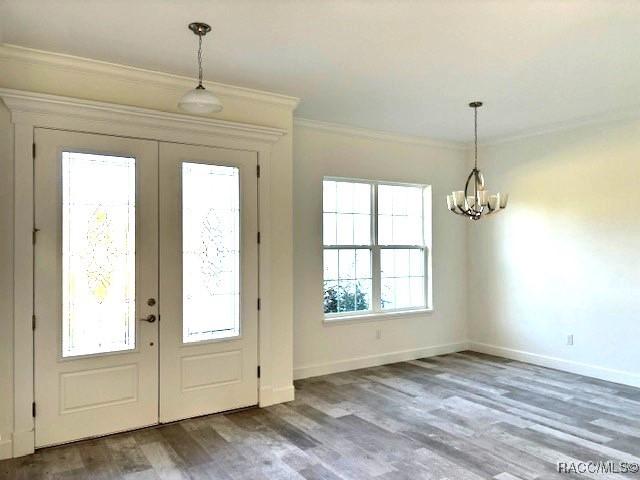4496 N Elkcam Blvd, Beverly Hills, FL 34465 - foyer featuring french doors, ornamental molding, a chandelier, and wood finished floors