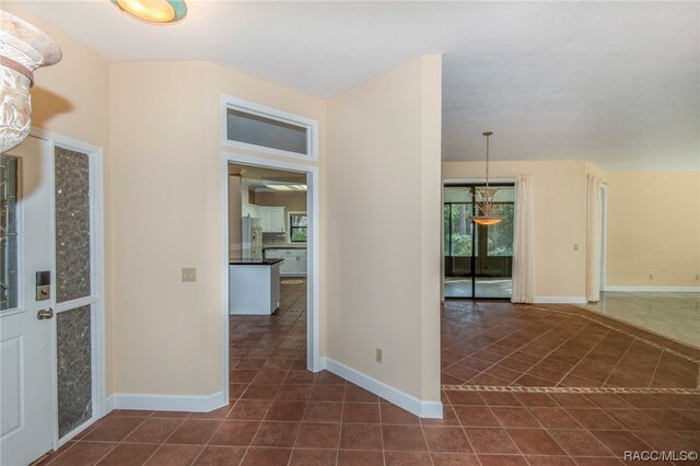 foyer featuring dark tile patterned flooring