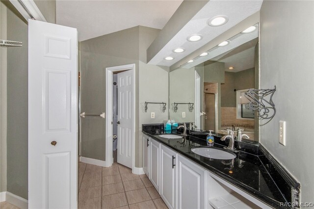 bathroom with tile patterned floors, vanity, and an enclosed shower