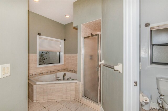 bathroom with tile patterned flooring, toilet, and independent shower and bath