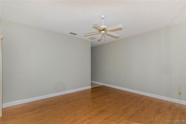 empty room with wood-type flooring and ceiling fan