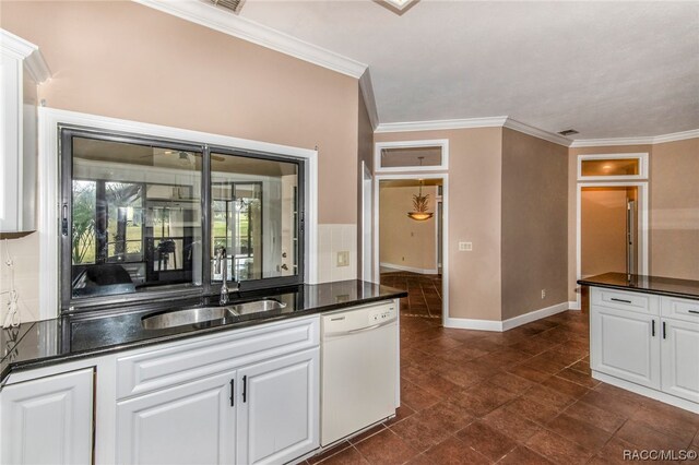 kitchen featuring white dishwasher, white cabinetry, dark stone countertops, and sink