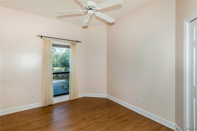 empty room featuring ceiling fan and dark wood-type flooring