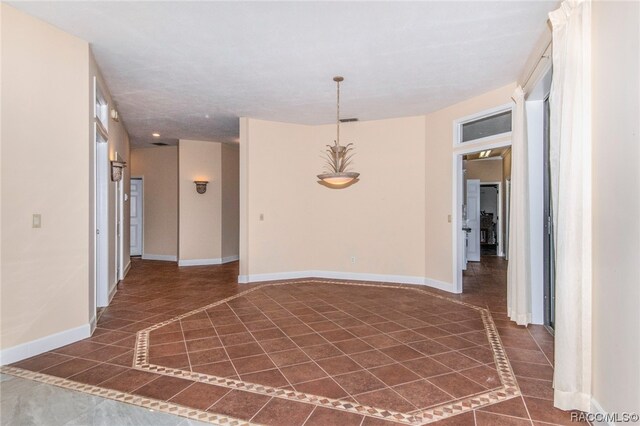 unfurnished room with dark tile patterned floors