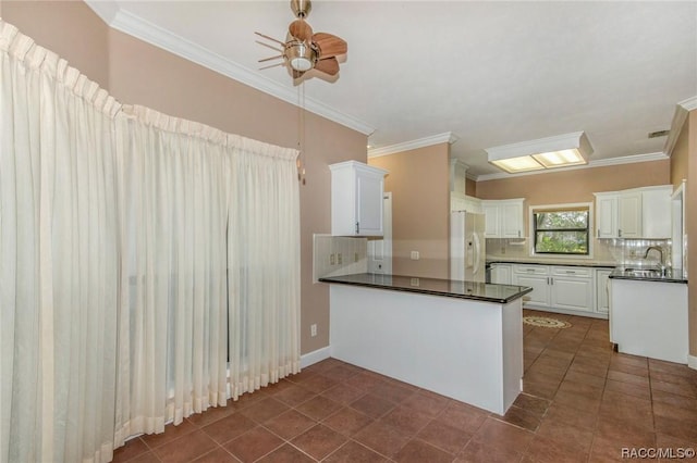 3356 N Bent Tree Pt, Lecanto, FL 34461 - kitchen with white fridge with ice dispenser, ceiling fan, dark countertops, a peninsula, and white cabinetry