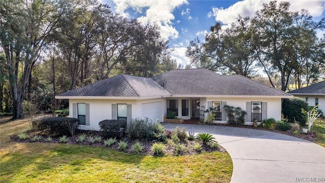 3356 N Bent Tree Pt, Lecanto, FL 34461 - single story home featuring curved driveway, stucco siding, an attached garage, and a front lawn