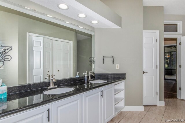 bathroom with tile patterned floors and vanity