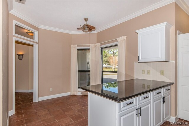 kitchen featuring white cabinets, crown molding, ceiling fan, decorative backsplash, and kitchen peninsula