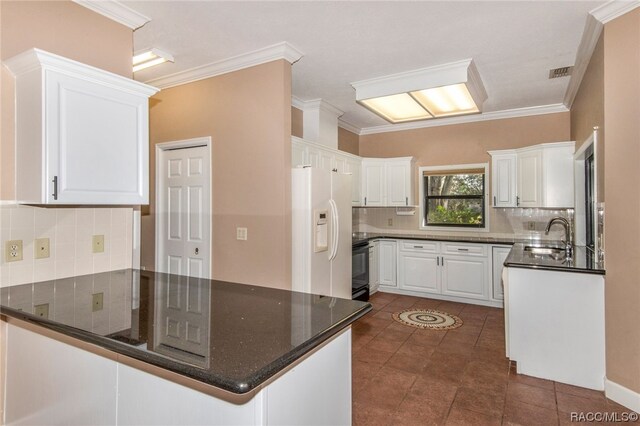 kitchen featuring white cabinetry, white fridge with ice dispenser, kitchen peninsula, decorative backsplash, and ornamental molding