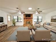 21389 SW 102cd St, Dunnellon, FL 34431 - living room featuring a ceiling fan, plenty of natural light, and a fireplace