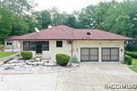 21389 SW 102cd St, Dunnellon, FL 34431 - view of front of property featuring concrete driveway and an attached garage