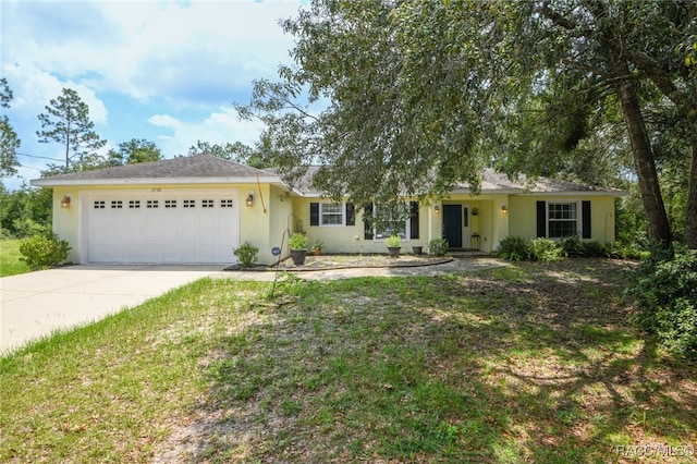 single story home featuring a front yard and a garage