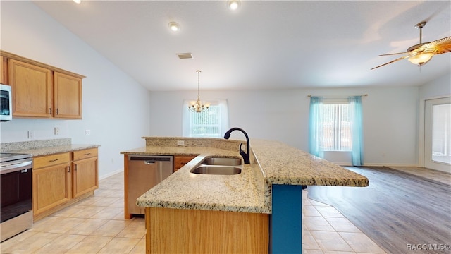 kitchen featuring sink, an island with sink, a wealth of natural light, and stainless steel appliances