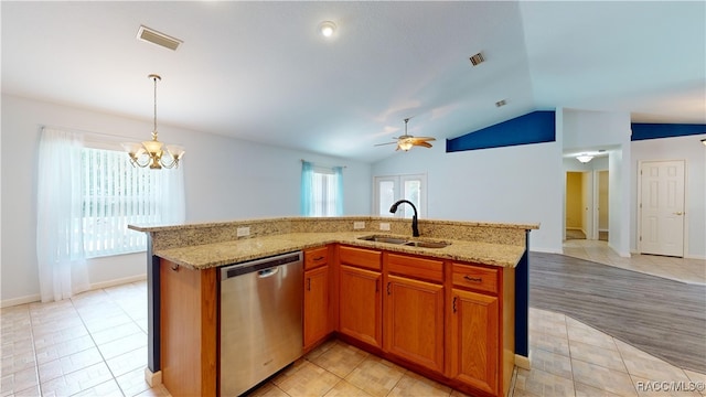 kitchen featuring ceiling fan with notable chandelier, sink, a center island with sink, dishwasher, and lofted ceiling