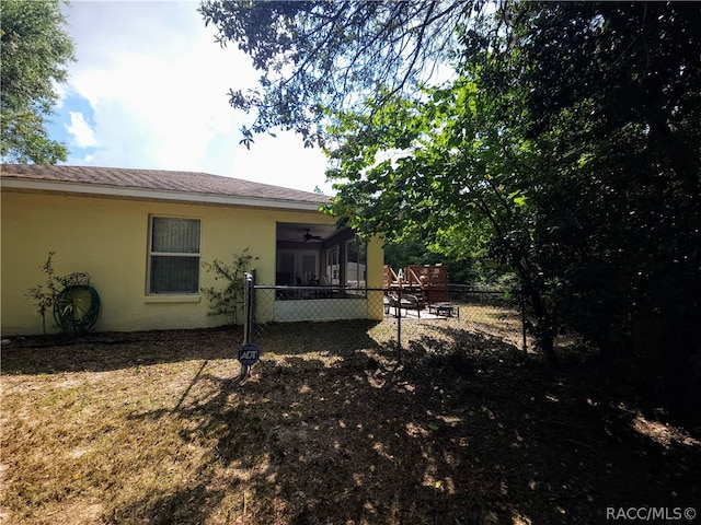 back of property featuring ceiling fan