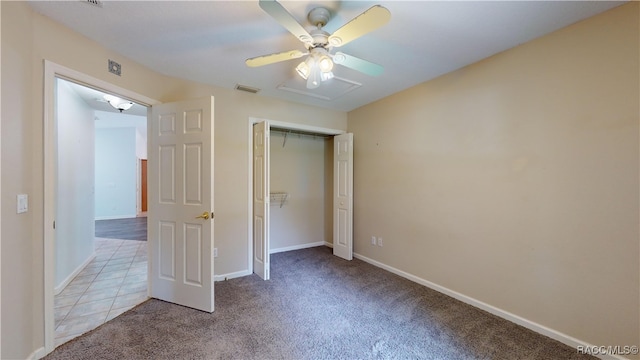 unfurnished bedroom with light carpet, a closet, and ceiling fan