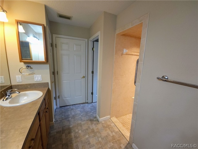 bathroom with a shower and vanity