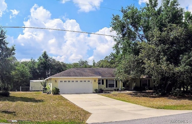 view of front of house featuring a front yard and a garage