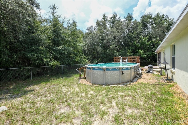 view of yard with a fenced in pool