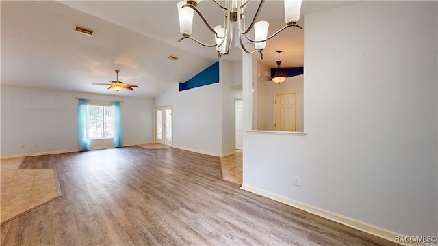 interior space featuring ceiling fan with notable chandelier, wood-type flooring, and high vaulted ceiling