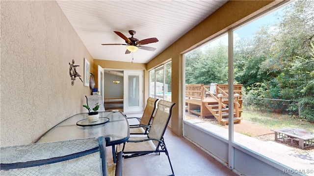 sunroom featuring ceiling fan