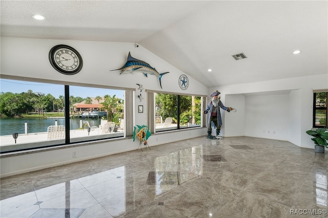 unfurnished living room with visible vents, a water view, recessed lighting, vaulted ceiling, and marble finish floor