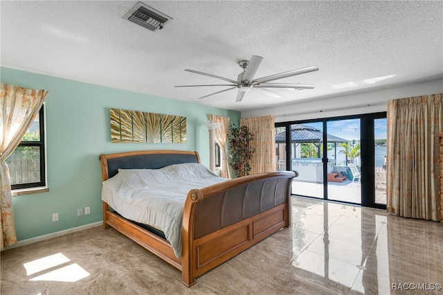 bedroom with baseboards, a textured ceiling, a ceiling fan, visible vents, and access to exterior