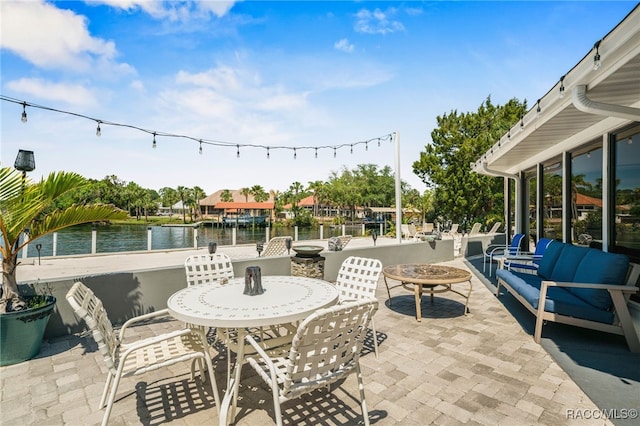view of patio with outdoor lounge area and a water view
