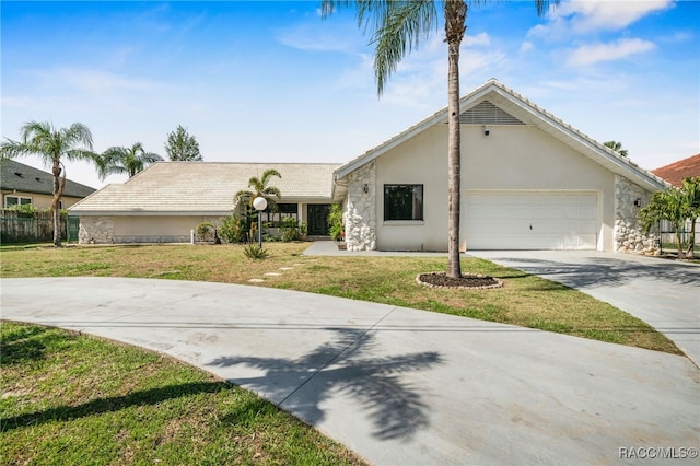 view of front facade featuring driveway, stucco siding, a front yard, and a garage