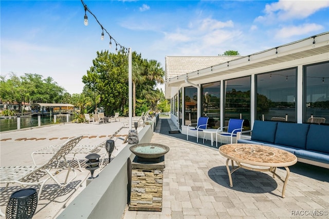 view of patio with an outdoor hangout area and a water view