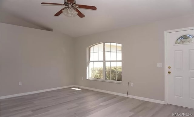 entrance foyer featuring ceiling fan, vaulted ceiling, and light wood-type flooring