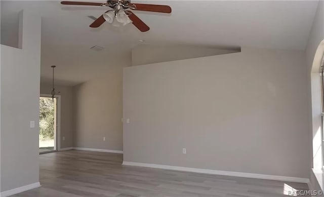 unfurnished room with ceiling fan, light hardwood / wood-style floors, and lofted ceiling