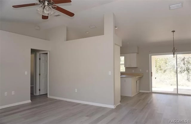 unfurnished living room featuring light hardwood / wood-style floors, ceiling fan, and lofted ceiling