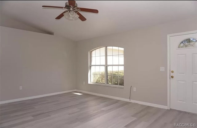 foyer entrance featuring ceiling fan, light hardwood / wood-style floors, and lofted ceiling