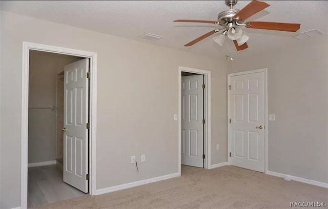 unfurnished bedroom with light carpet and ceiling fan