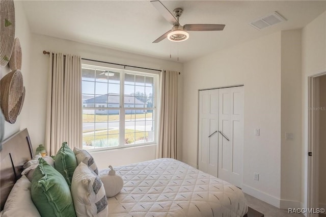 bedroom with ceiling fan and a closet