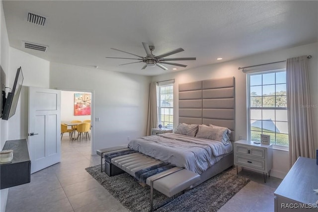 tiled bedroom with ceiling fan