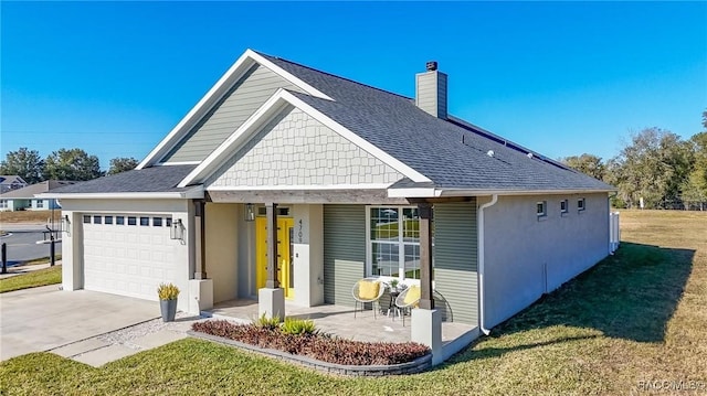 view of front of house with a garage, a porch, and a front yard