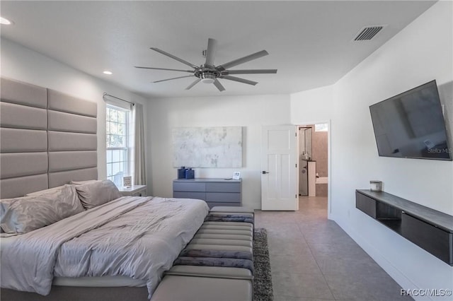 bedroom with tile patterned flooring, connected bathroom, and ceiling fan