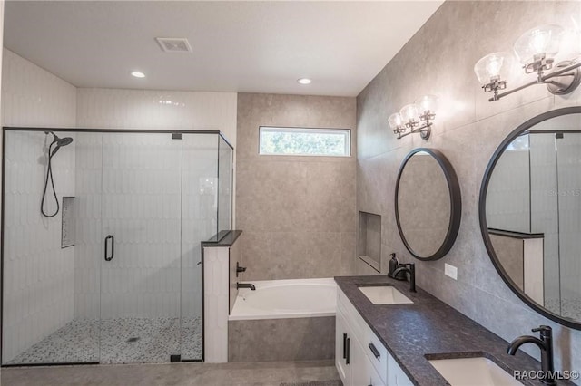 bathroom featuring independent shower and bath and vanity